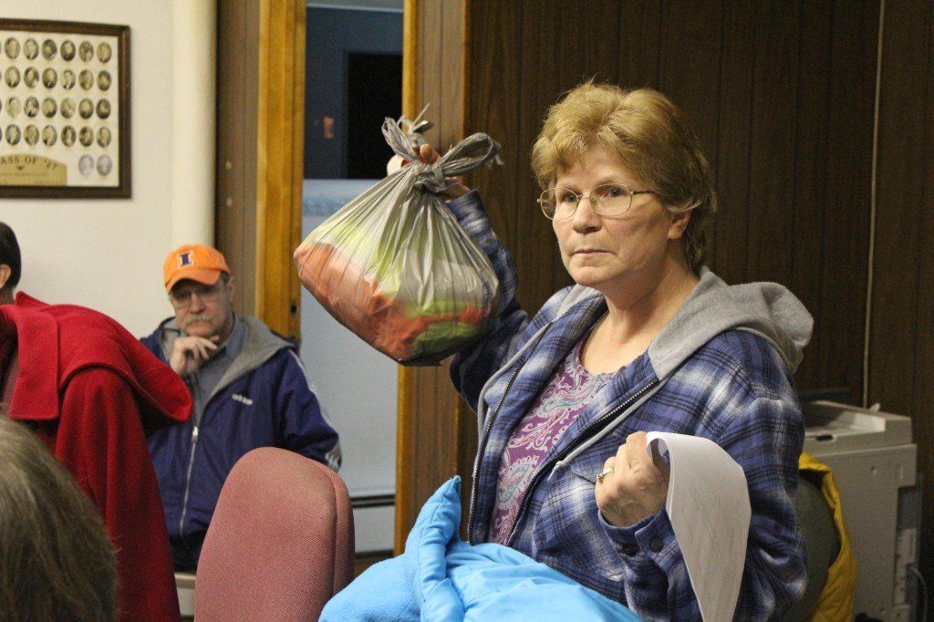 Bonnie Zirkelbach holds up the shirts she purchased for the maintenance crew. The city denied to reimburse her the amount. Read more. 