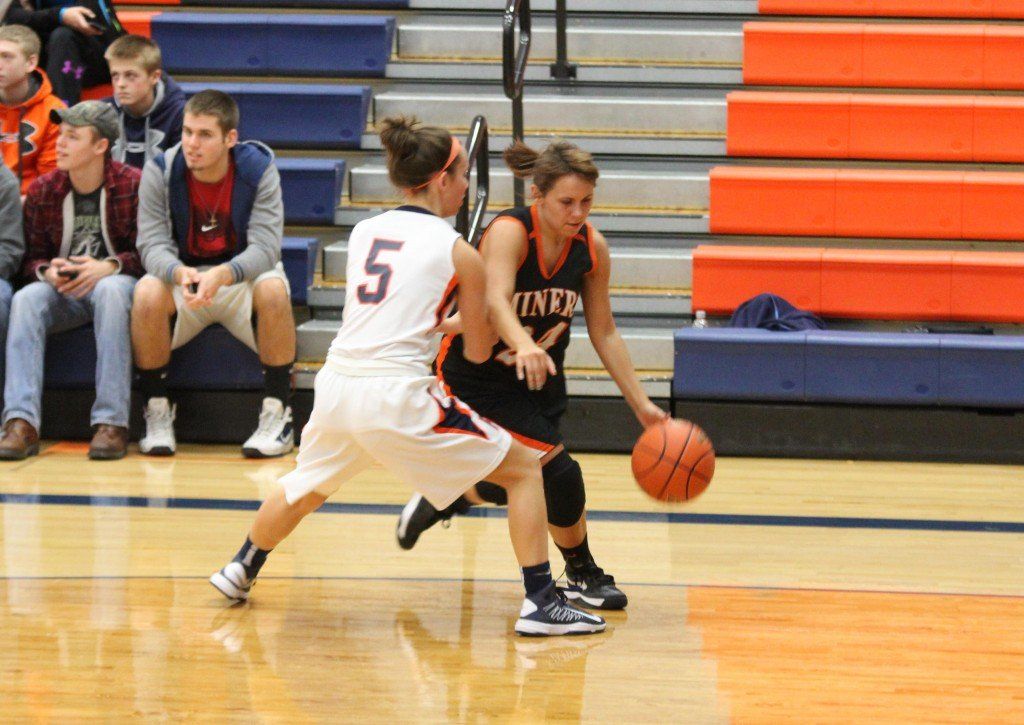 Chelsea Gill attempts to drive around the defender. 