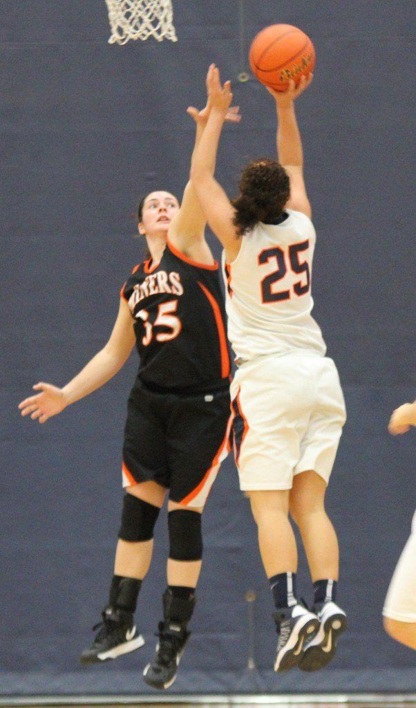 Haylie Kirkwood gets a hand in the offenders face to attempt to distract the shot. 