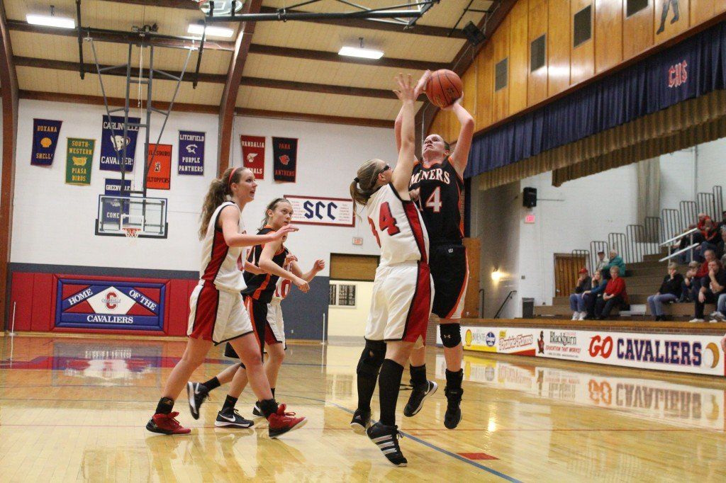 Alexis Burns hits the jumpshot with the hand in her face. 