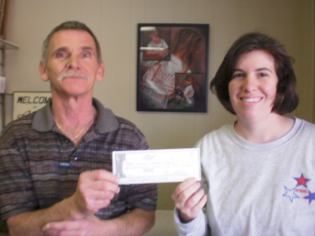 Macoupin Military Support Group accepts a donation.