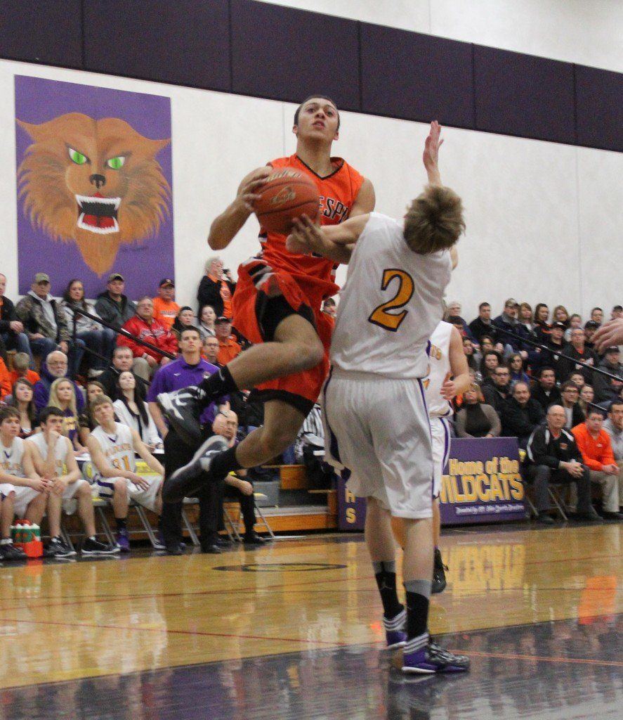 Chris Halpin leaps through the air as he lays the ball in for an easy two points. The Miners defeated Mt. Olive 65-54.