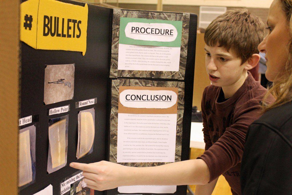 Trevor Fredericks explains his science fair project to Julie Wargo Wednesday evening during the annual Fredericks earned the "Best in Physics" award. Read more about the event.