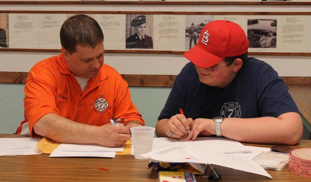 Lance Cooper and Will Bertetto tally the votes during the Benld Fire Department's annual trivia night. 