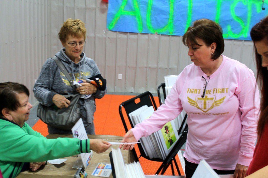 Cathy Visintin makes a purchase from Genece Hamby at the Ageless Spin-a-thon market Saturday morning. 