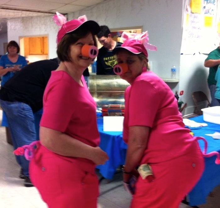 Donna Easton and Brenda Lowe show off their pig costumes as the pair sold raffle tickets during the Todd Savant benefit. 
