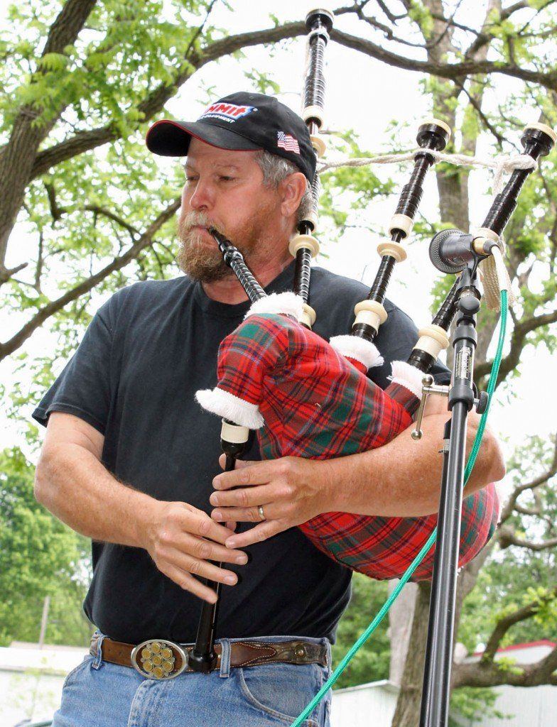 Joe Readnour, of the band Thrashin' Grass, plays the bagpipes during the Macoupin County Historical Society's Spring Festival. The band played two sets Sunday, one electric and the other acoustic.