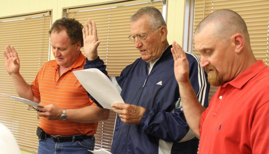 Reelected board members Dave Griffel, Don Dobrino, and Bill Carter get sworn in.