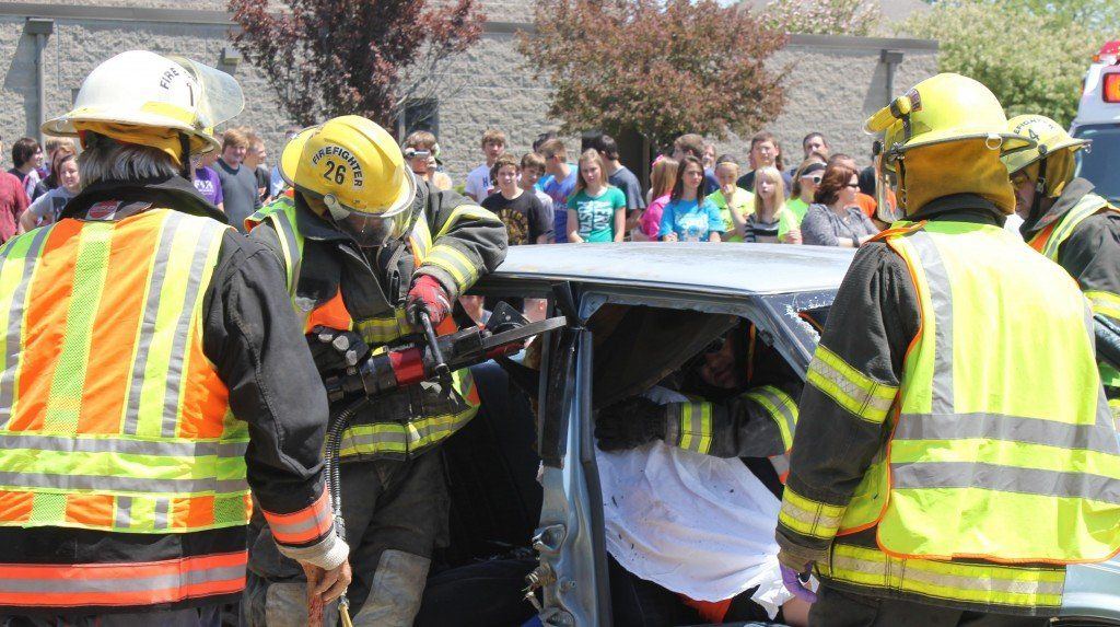 Crews eventually tear off the roof of the car to get to one victim.