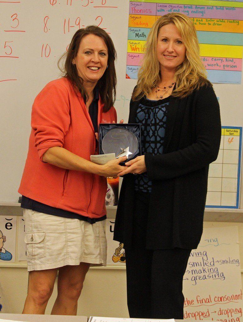 Amy Price receives her plaque for being chosen as Madison's Teacher of the Year. Sara Crook presented Price with her plaque. 