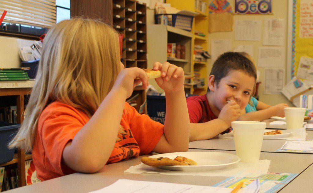 Students from Mrs Price's class enjoy the free pizza and cookies Madison supplied on behalf of their teacher winning the award. 