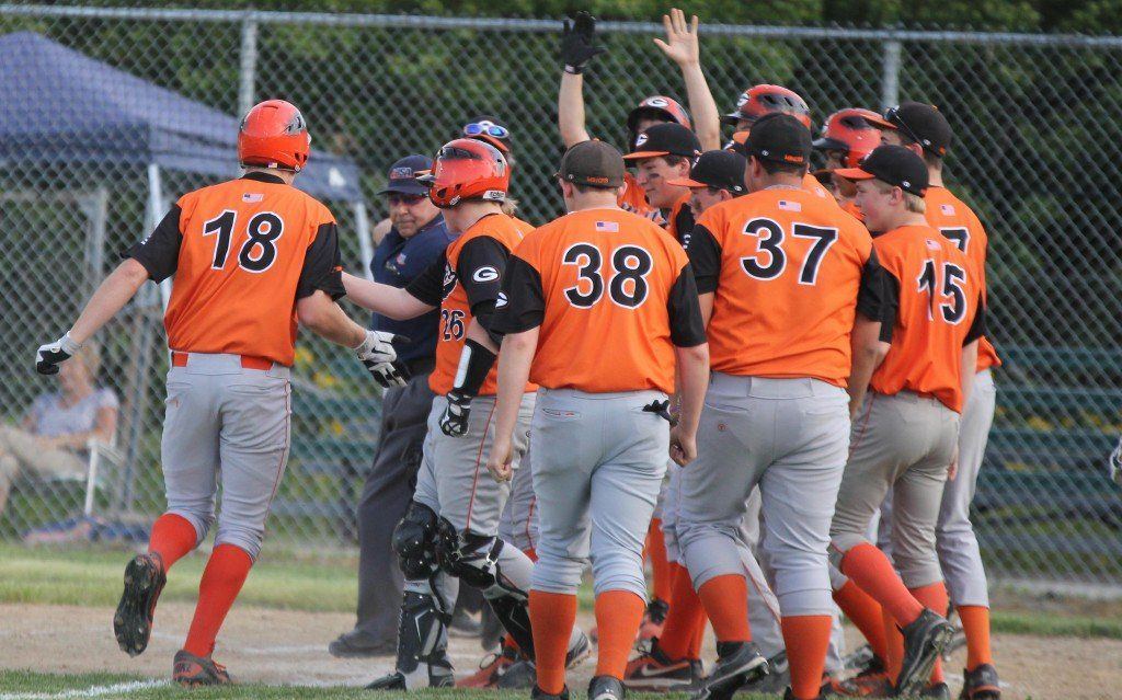 The baseball team gathers around home as they welcome Joe Janssen in after Joe hit a 3-run homerun in the regional semi final game. 