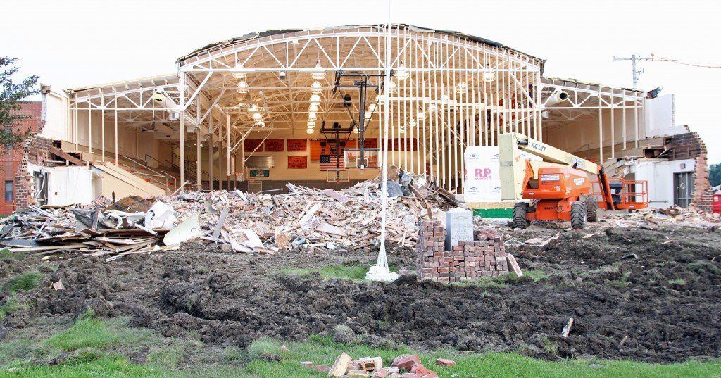 Crews work to build a temporary wall inside the Gillespie High School gymnasium early this past week. Superintendent Skeans explained the district is going to try to save the gym. Read more.