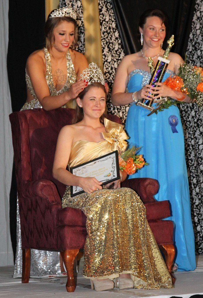 2012 Miss Black Diamond Days Kortney Carr crowns 2013 Miss Black Diamond Days Abigail Harszy on Friday evening in the first night of the weekend festivities. Kaitlin Henrichs looks on with her 1st runner-up trophy.