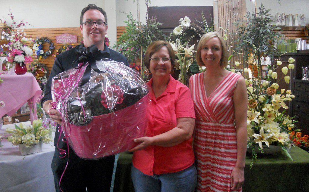 Progressive Retailing Day Gift Basket Winner Phylis Cox (center) of Bunker Hill with Brick House Florist owner Thom Ward and MEDP Marketing Specialist Courtney Wood.