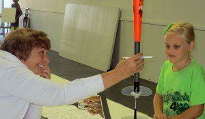 Braylee Gilmore of Lucky Birds 4-H explains her aerospace project to her judge.