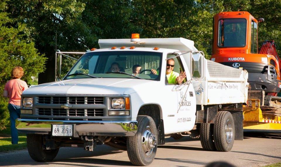 G&L Services drive thru the Dorchester Homecoming Parade Saturday evening pulling some of their equipment.