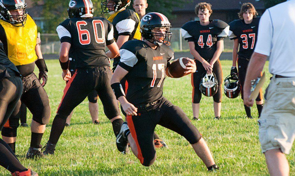 To kick off the football season, the Miners held a scrimmage against their own team. Above, Michael Henderson carries the ball up the middle looking for room to run.