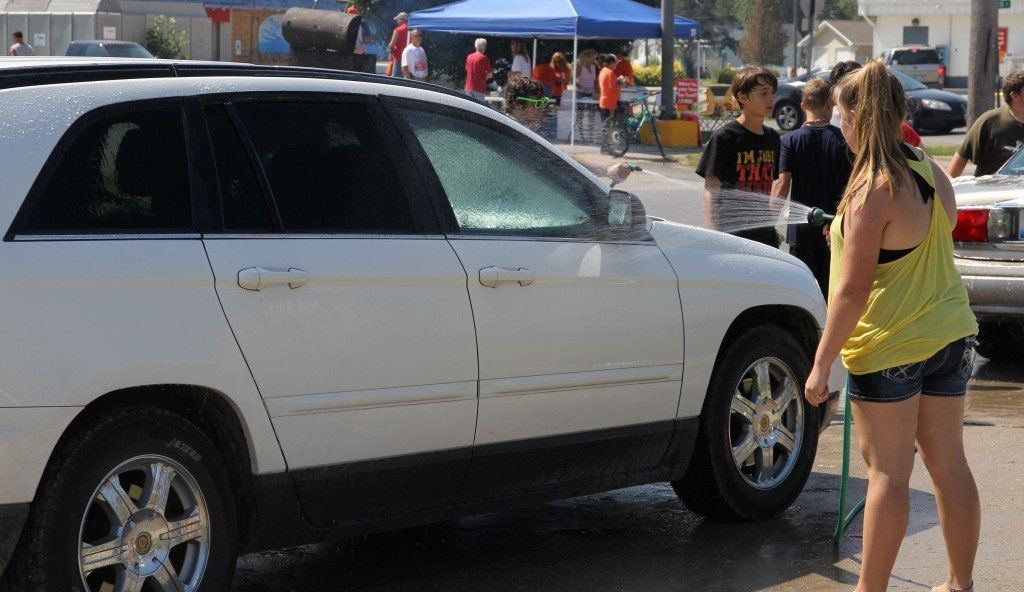 Cars lined up waiting to get washed in the choir's annual car wash and cookout fundraiser.