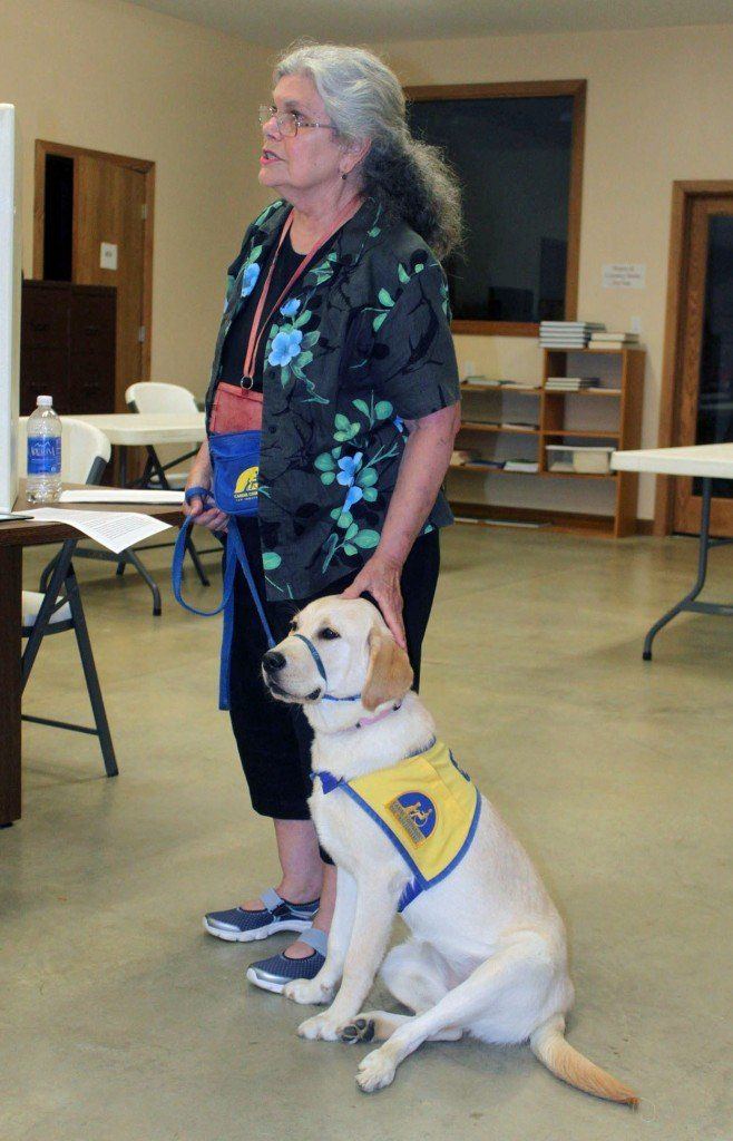Accompanied by 7-month-old Weeka, puppy raiser Pat Sims speaks about her passion for raising service puppies for Canine Companions for Independence, a dog service organization that pairs service dogs with people who have disabilities, during  the Macoupin County Historical Society's August meeting. 