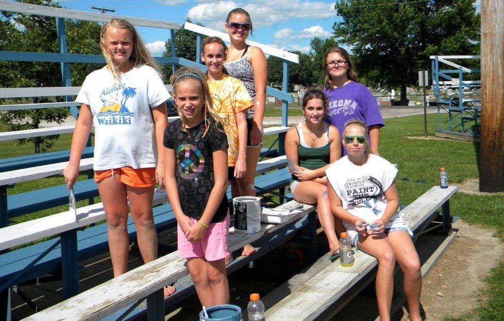 Members of the Gillespie Orange Crush girls softball teams volunteered their time to paint the bleachers at Welfare Park on Saturday, July 27th.