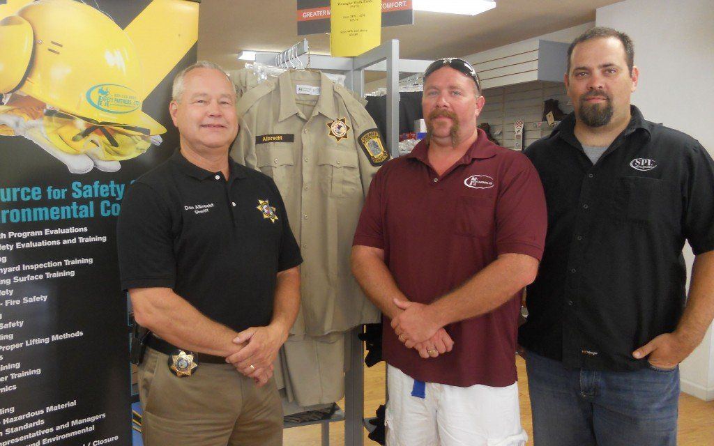 Sheriff Don Albrecht alongside the new County Sheriff’s Department uniform prototype with Safety Partners Ltd. President CEO Owner Dave Volentine and General Manager Nathan Sparrowks.
