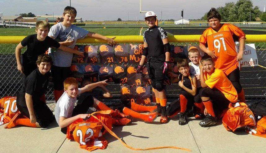 A few of the 8th grade Mustang players pose next to their "homecoming" decorations following their victory over Hillsboro.