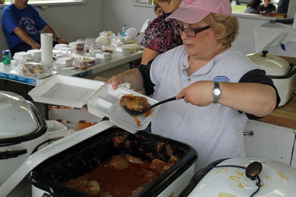Stephanie Dragovich serves up a take-home tray of cabbage rolls.
