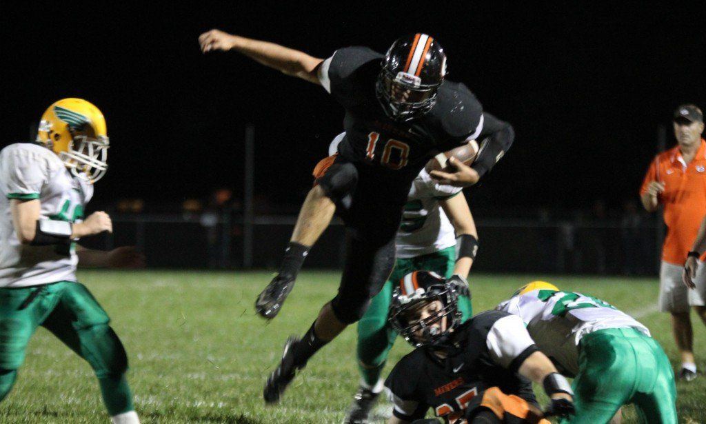 Logan Cooper high steps over his teammate to avoid any injuries in Friday night's matchup.