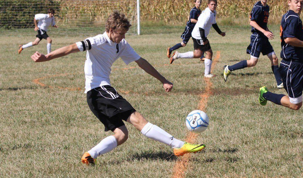 Blake Hayes centers the ball to midfield in the Miners matchup with Pana Saturday morning. The Miners lost 2-1.