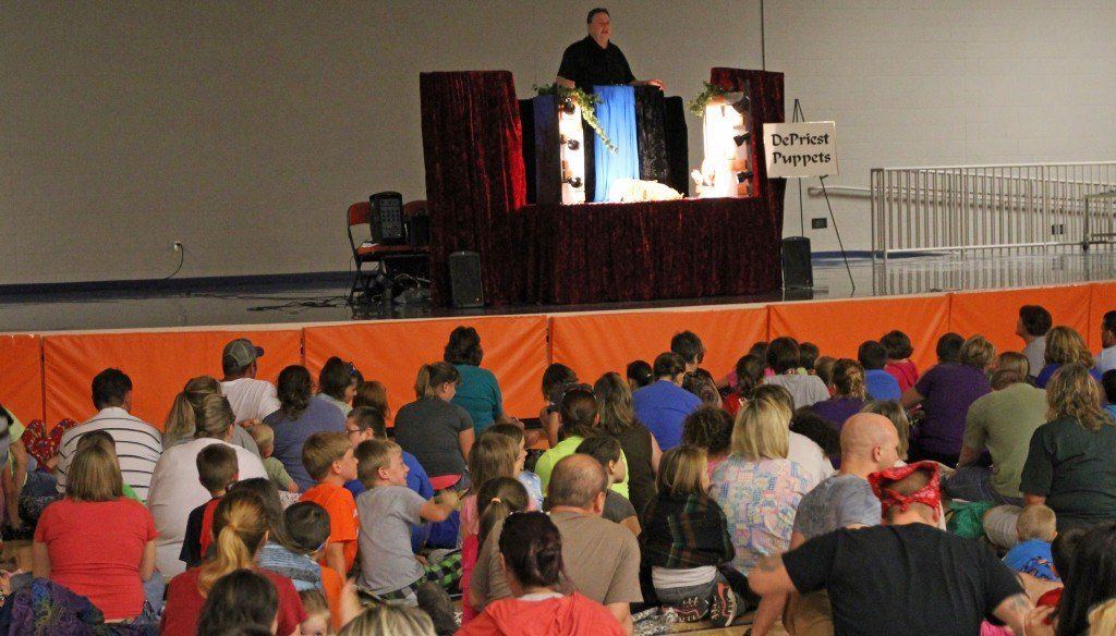 Students and parents enjoy a puppet show hosted at the Family Literacy Night inside the new Ben-Gil Elementary School.