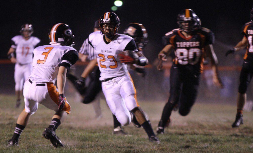 Chris Halpin dodges an opponent and finds running room in the Miners' 36-21 victory over Hillsboro Friday evening.