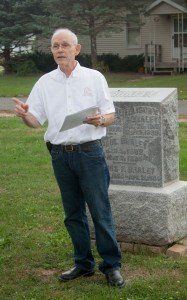In front of Elison Braley’s grave and out of costume, Ralph Scheldt portrays Braley, during a rehearsal for the Tombstone Tales, a walking tour, which will take place this Saturday at Carlinville City Cemetery. Photo by Louise Jett