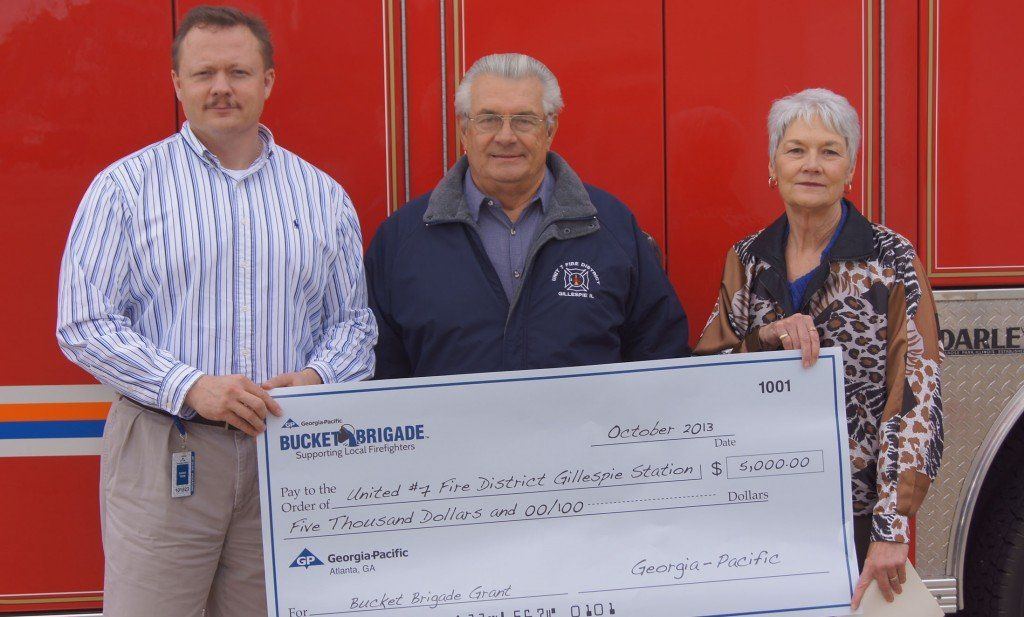 Georgia Pacific presents Larry Norville with a $5,000 grant to be used at the Gillespie Fire Station.