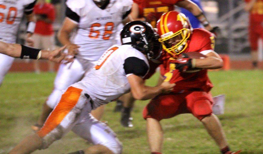 Logan Cooper tackles his opponent in the backfield for a sack. Cooper gathered 9 tackles last Friday.
