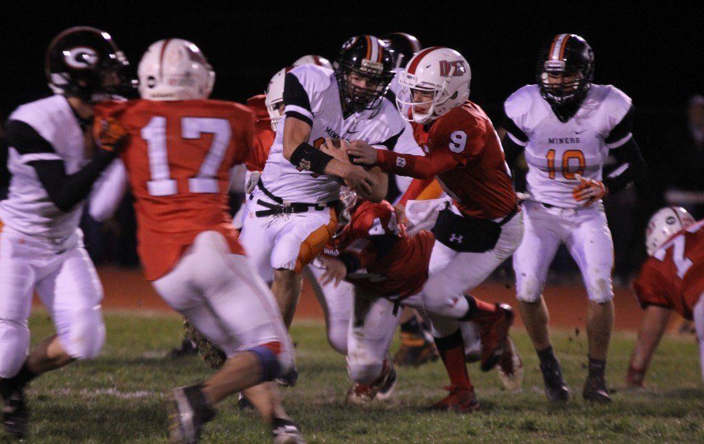 Logan Cooper rushes up the middle last Friday evening in the Miners' matchup with Staunton. The Miners beat the Bulldogs 38-8.