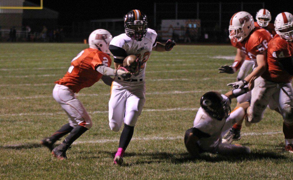 Blake Peterson tries to gain a few extra yards on a rushing attempt. The Miners won 38-8.