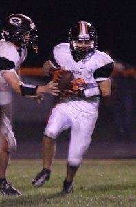 Michael Henderson hands the ball off to Blake Peterson. Henderson finished the game with 114 rushing yards and 135 passing yards.