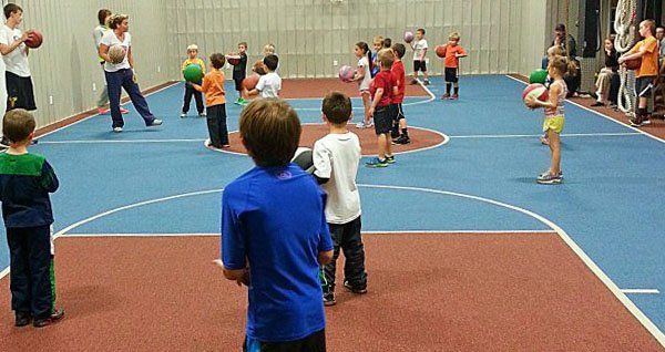 Kids partaking in the Ageless Little Dribblers class listen to instructions.