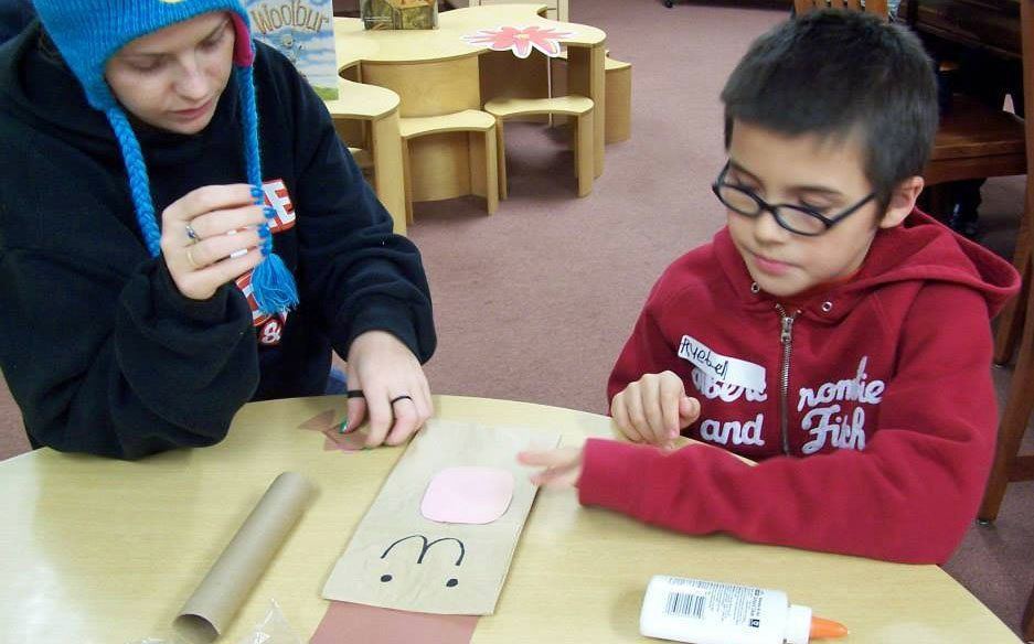 Children at the Gillespie Library have fun reading stories about squirrels and creating crafts that looked like acorns.