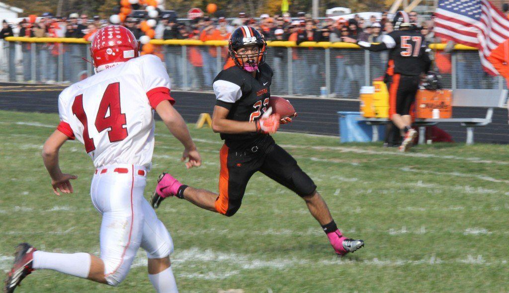 Chris Halpin looks his defender in the eye before blowing past him in the Miners' first playoff game. The Miners won 28-14 and Halpin had 1 rushing touchdown and 1 touchdown reception. 