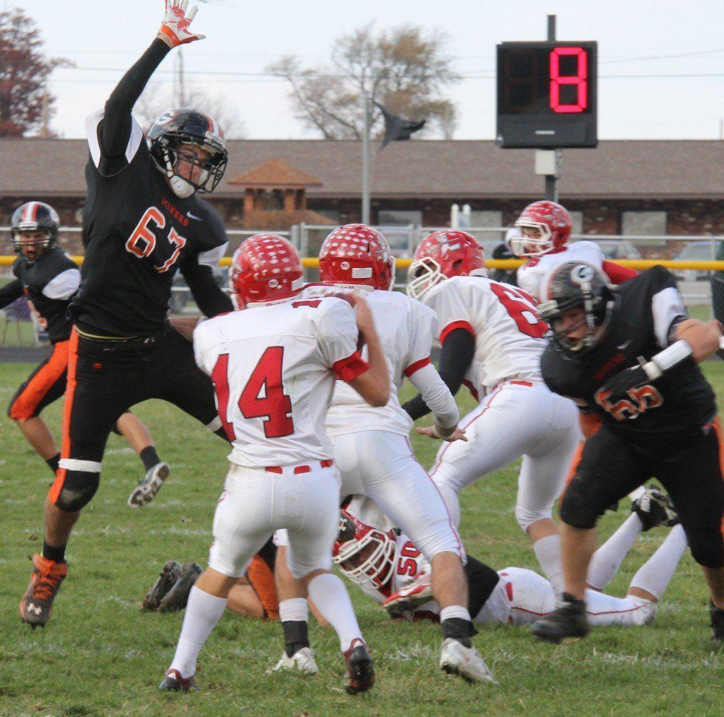 Hunter Vesper, left, and Ian Wilder, right, take down the Indian's quarterback in the backfield. 