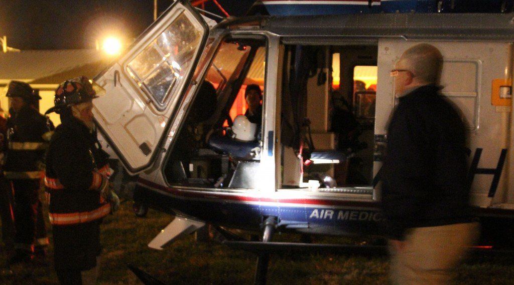 Firefighter Lance Cooper takes a close looker inside the helicopter as he's guided by an Arch member.