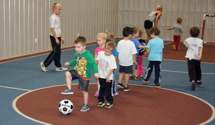 The Little Kickers at Ageless line up to take a shot at the goal.