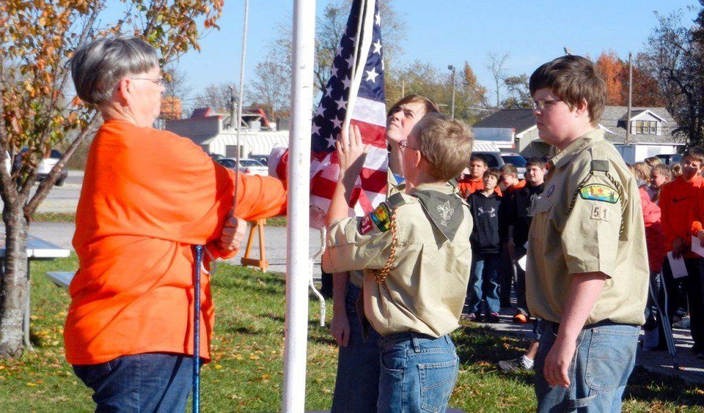Miss Olson and boy scouts raise a new flag at Gillespie Middle School in honor of Veteran's Day. Read more about Veteran's Day at GMS here.