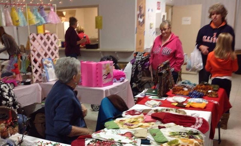 Customers browse selections offered by tons of vendors on hand at the Holiday Market offered by Education Station. 