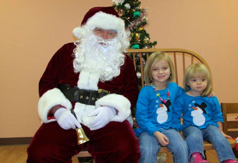 Santa made a stop at Benld Public Library last week and took photos from visitors. Pictured are the Heyen girls cheesing with Santa.