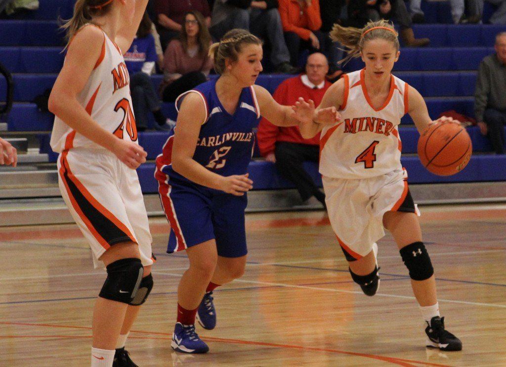 Bette Hammann dribbles around her defender in the Lady Miners' game versus Carlinville this week. The Miners came up short 41-52.