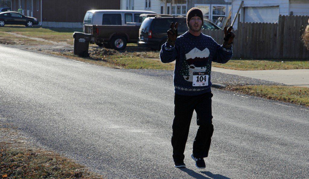 Jason Verity shows love to the camera in Ageless' Ugly Sweater 1 mile/5K run early Saturday morning. Nearly 40 people turned out for the cold event.