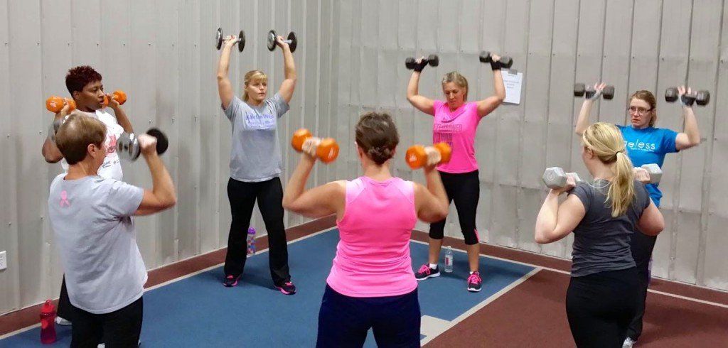 A group of ladies do a set of exercises together in Ageless' morning madness class. 